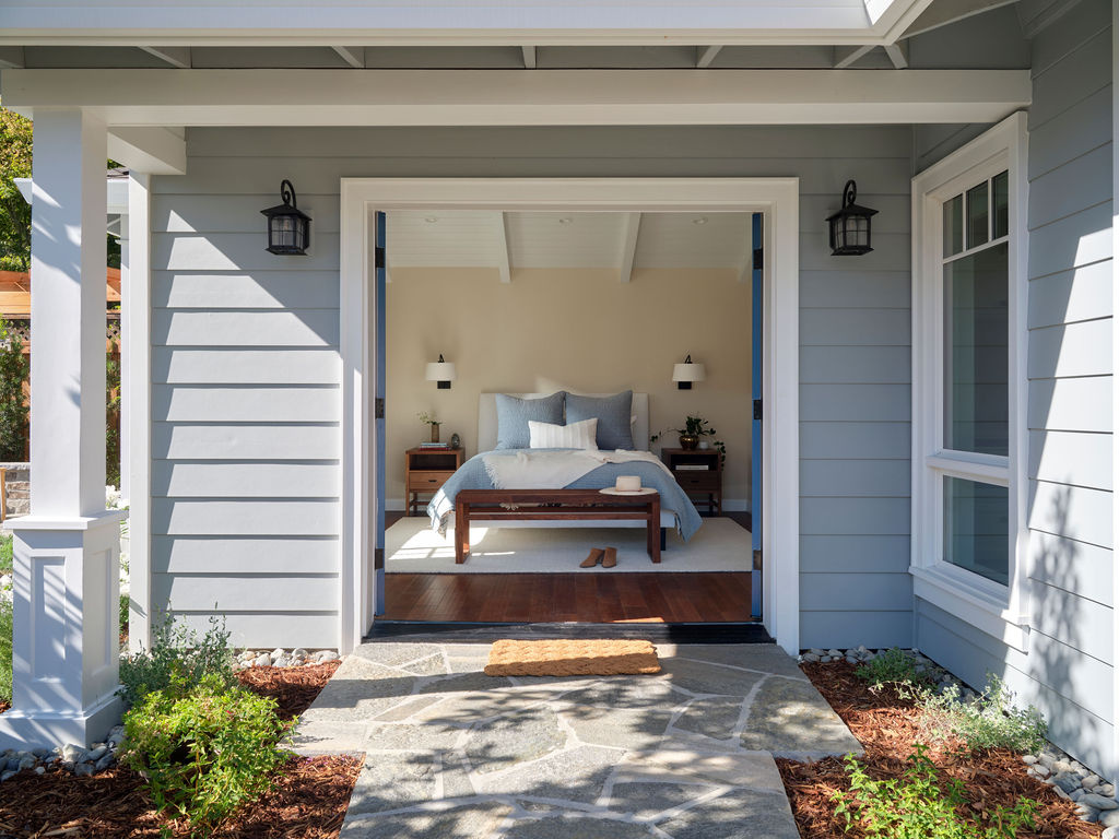 adu bedroom opening to a covered patio and stone path by mak design build in davis ca
