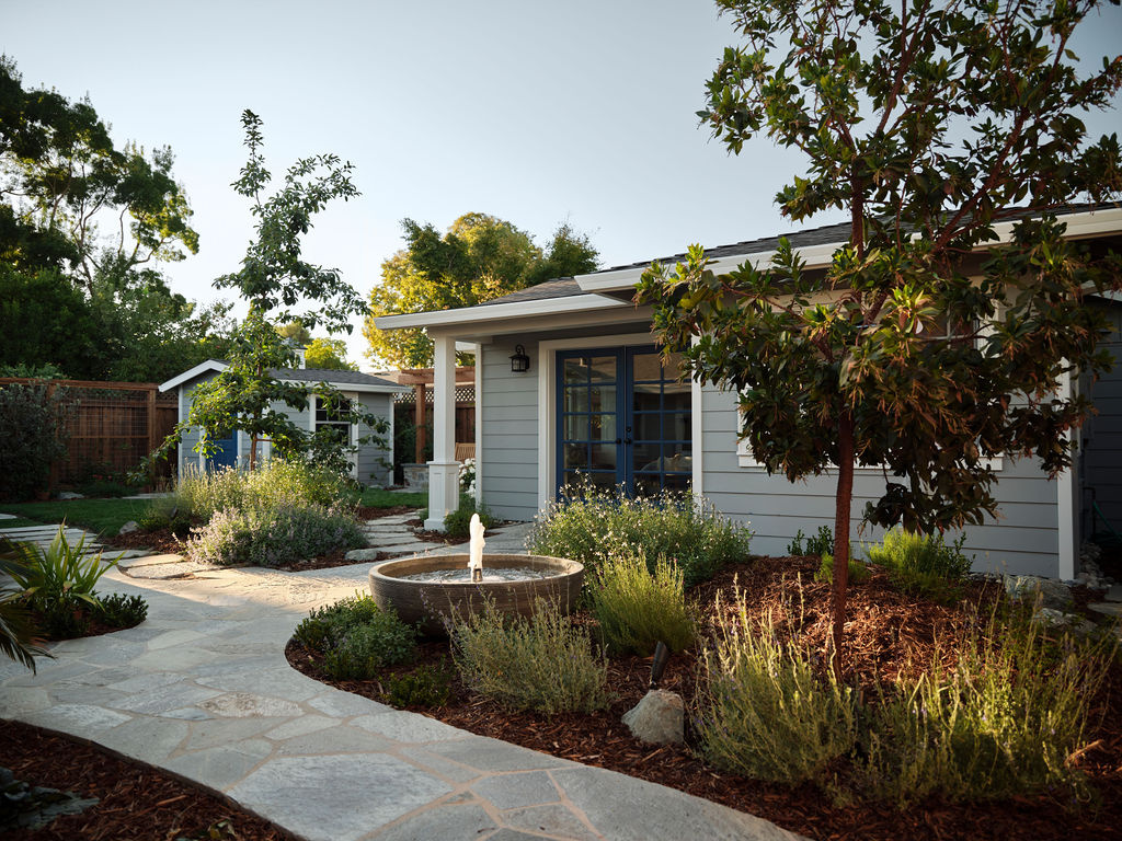 traditional adu exterior with garden fountain and stone pathways by mak design build in davis ca