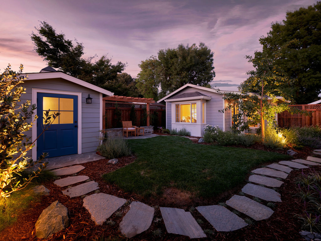 adu and matching garden shed with blue doors at dusk by mak design build in davis ca