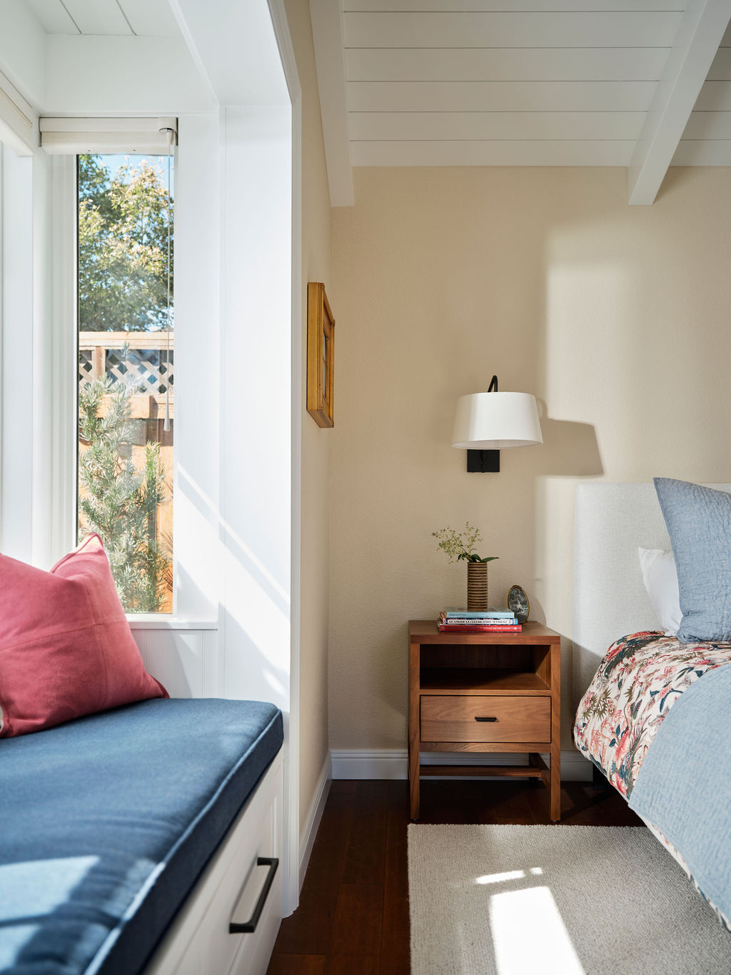adu bedroom with wall sconce and built in window seat by mak design build in davis ca