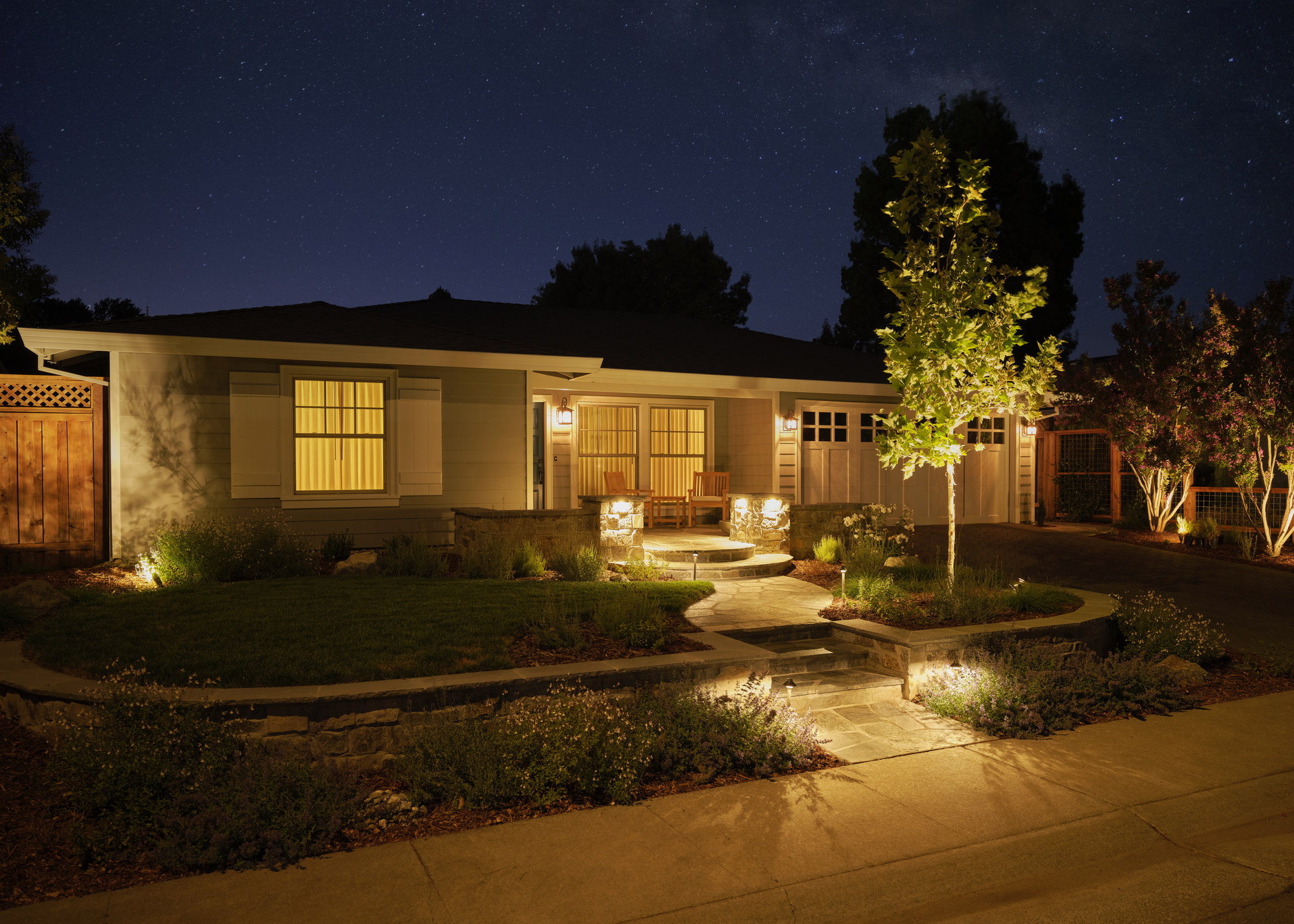 adu exterior and landscaped garden illuminated at night by mak design build in davis ca