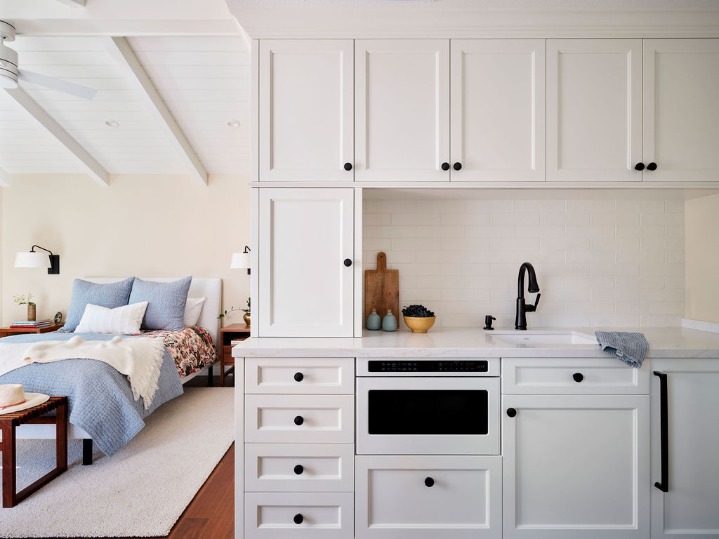 compact adu kitchenette with white cabinets and vaulted ceiling by mak design build in davis ca