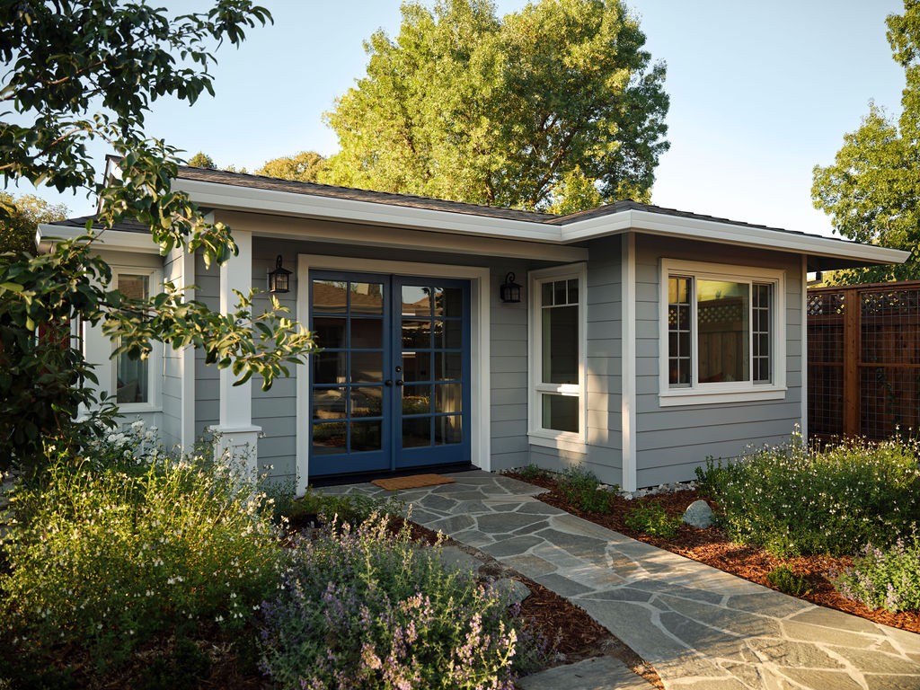 traditional adu exterior with blue entry doors and stone pathway by mak design build in davis ca
